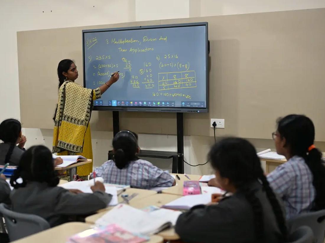Middle school students following a lesson on the smart board