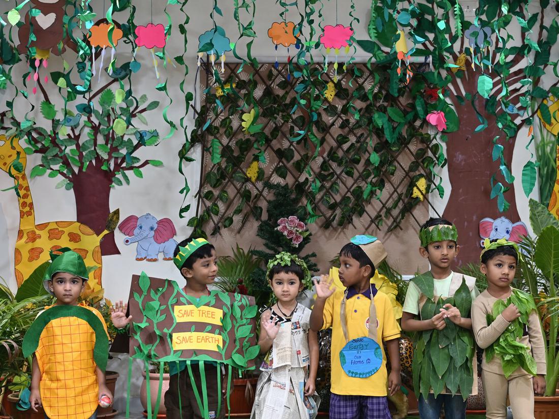 Primary students writing at their desks in a classroom