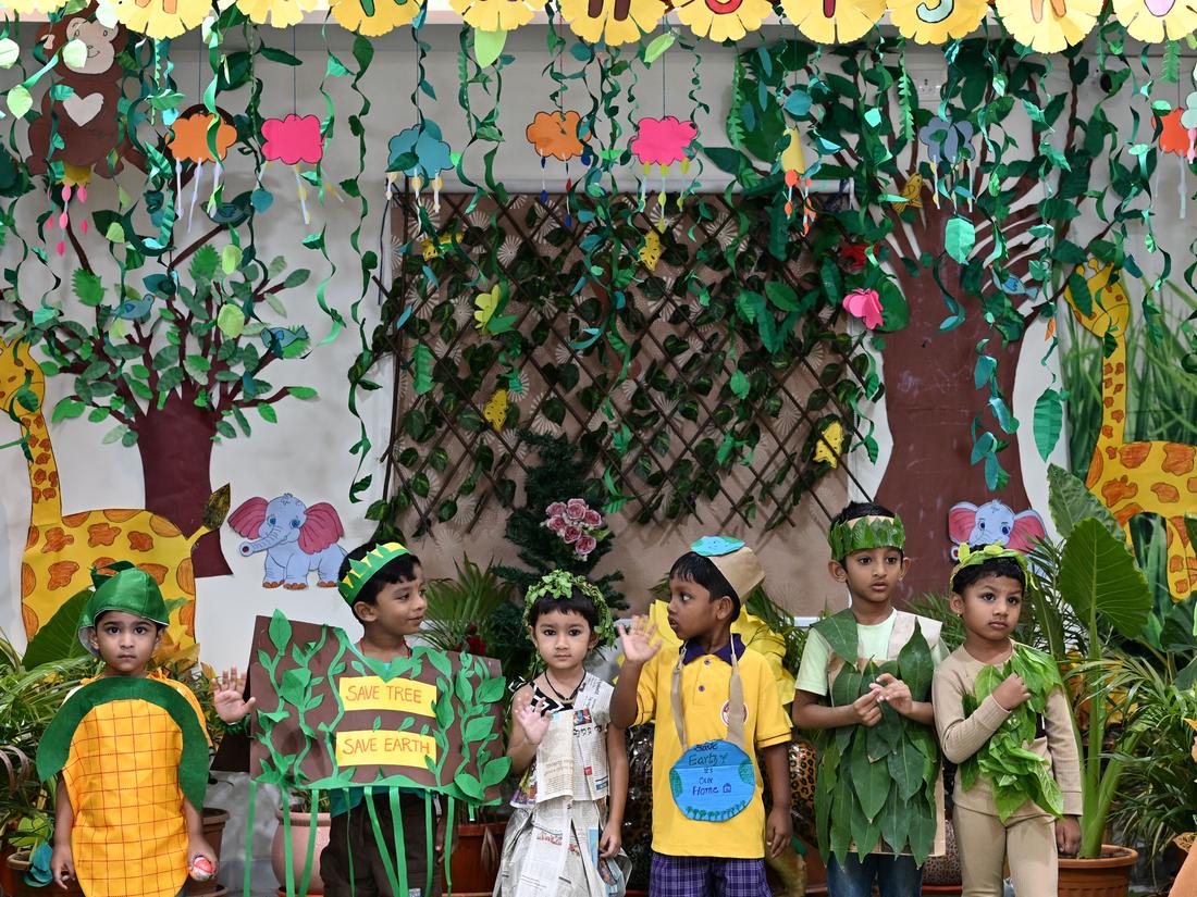 Children in costumes performing at a school celebration