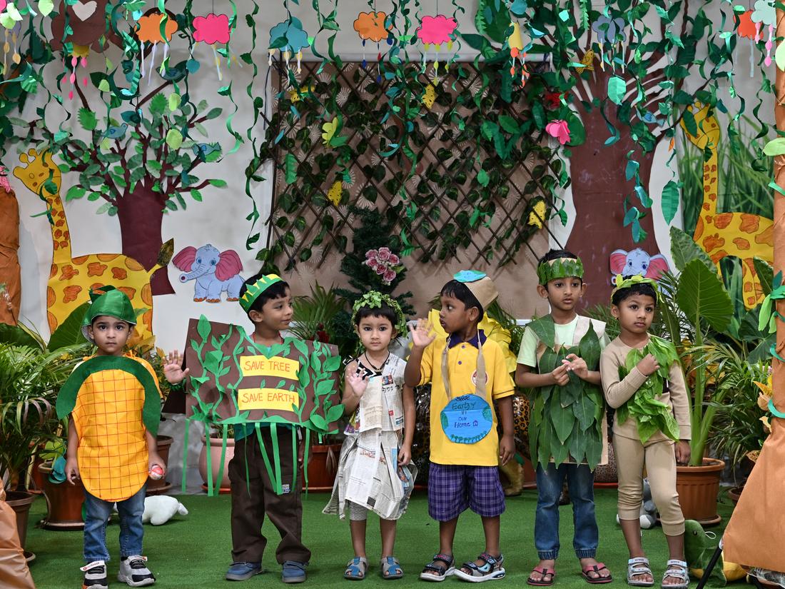 Nursery children in colourful costumes during a school celebration