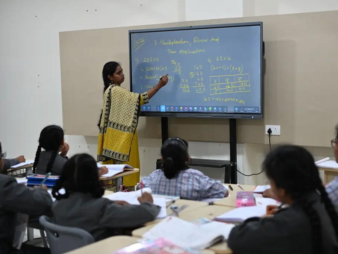 Teacher using an interactive smart board in class