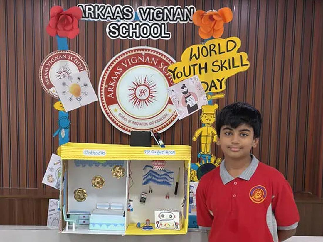 Middle school student with a handmade science project model at a skills day