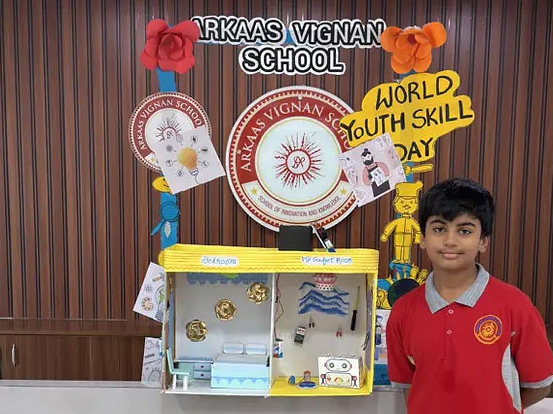 Student standing proudly beside a project at a skills day Student standing proudly beside a project at a skills day
