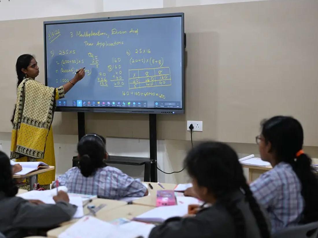 Teacher teaching with an interactive smart board